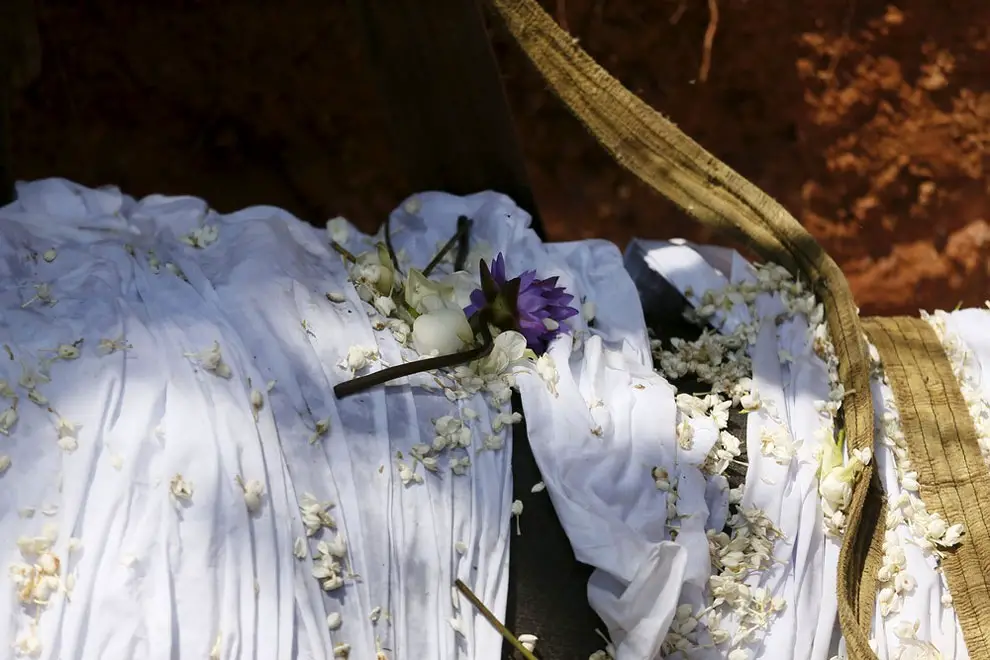 Flowers offered by local villagers seen on the dead body of elephant Hemantha is seen during a religious ceremony at a Buddhist temple in Colombo March 15, 2016