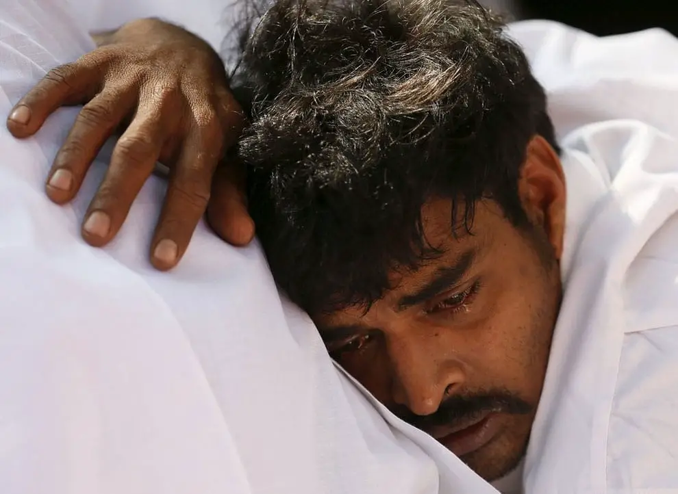 Mahout Wasantha cries next to his elephant Hemantha’s dead body during a religious ceremony at a Buddhist temple in Colombo March 15, 2016.