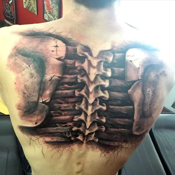 man-with-black-ink-shaded-realistic-spine-tattoo-on-back