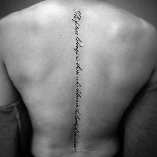 simple-cursive-lettering-quote-spine-tattoo-on-man