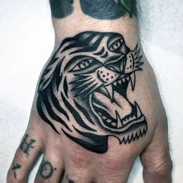 guy-with-shaded-black-and-grey-traditional-roaring-tiger-hand-tattoo