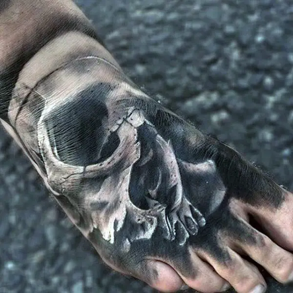 eerie-skull-on-foot-tattoo-for-guys