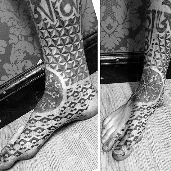 guy-with-gray-snowflake-and-tile-design-tattoo-on-foot
