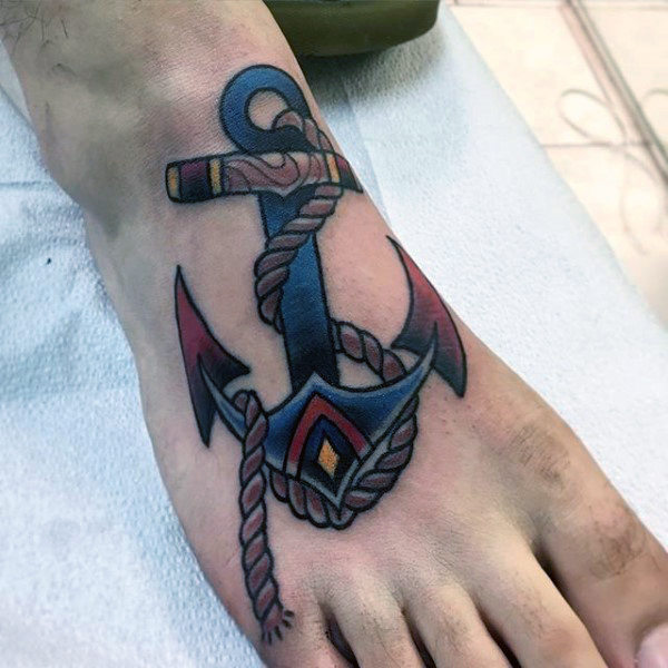 man-with-navy-blue-anchor-tattooo-on-foot