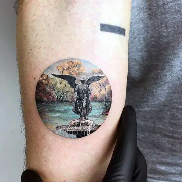 mens-statue-over-river-circle-small-unique-arm-tattoos