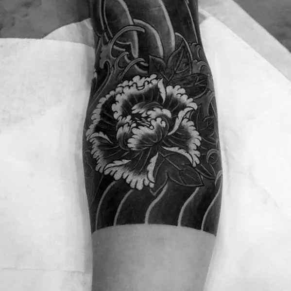 black-ink-shaded-japanese-flower-tattoo-on-male