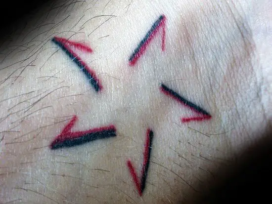 unique-black-and-red-ink-negative-space-simple-star-tattoos-for-guys-on-wrist