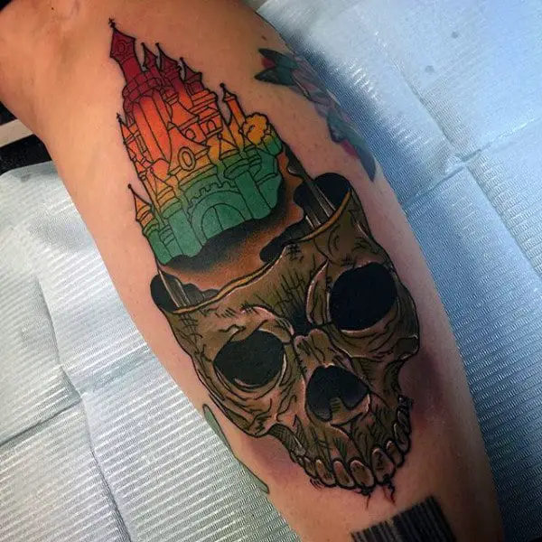 mens-tattoo-with-colorful-castle-on-dark-skull-cliff