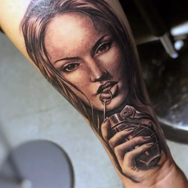 woman-holding-grenade-tattoo-on-man