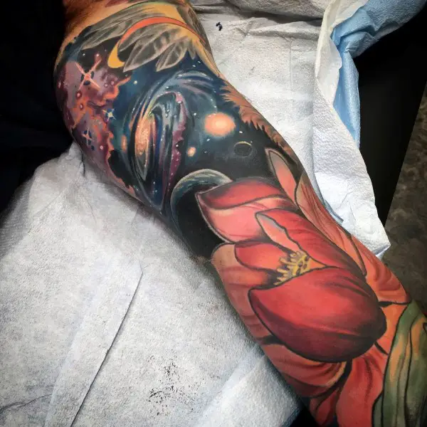 male-with-lotus-flower-outer-space-sleeve-tattoo