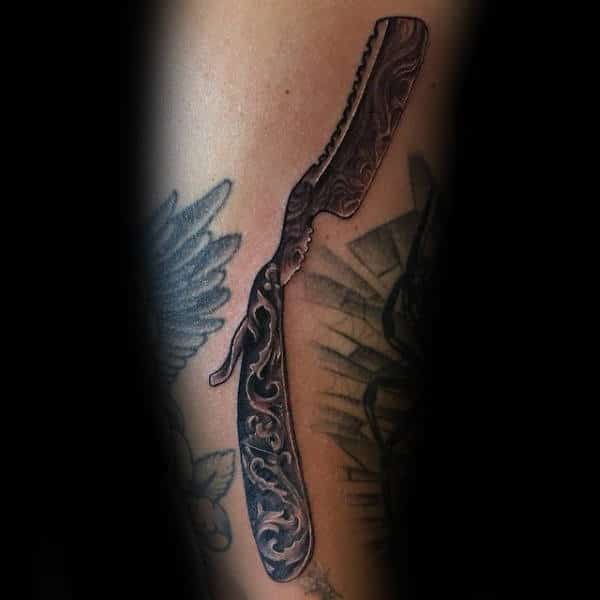 ancient-carvings-on-straight-razor-blade-tattoo-male-forearms