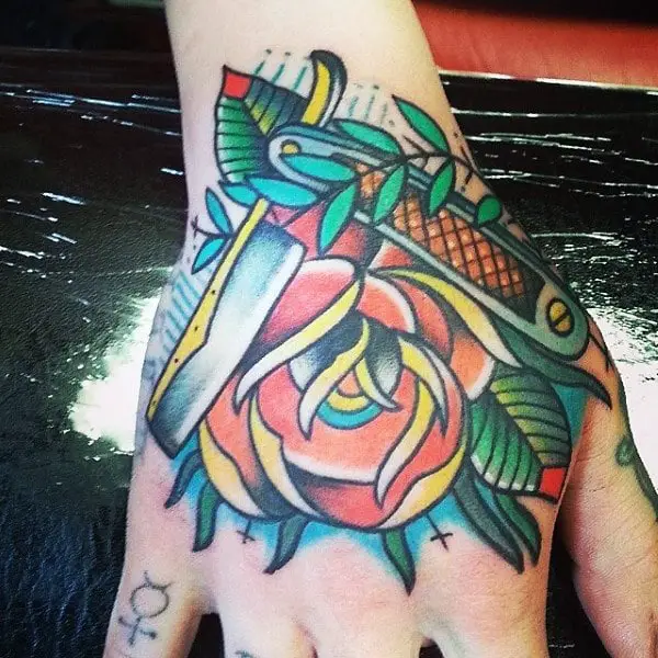 colorful-tattoo-of-flowers-and-straight-razor-male-hands