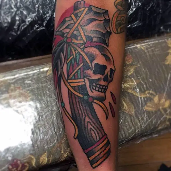 guy-with-skull-and-old-school-tomahawk-design-tattoo-on-forearm