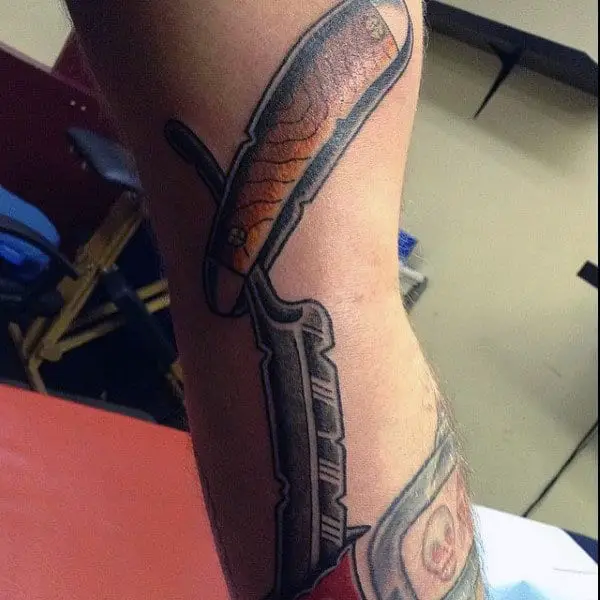 guy-with-wonderful-straight-razor-tattoo-on-forearm