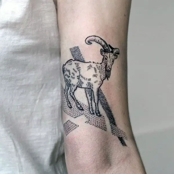 man-with-capricorn-goat-dotwork-tattoo-on-inner-arm