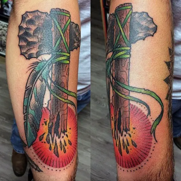 rising-sun-broken-wood-tomahawk-tattoo-with-feathers-on-mans-arm