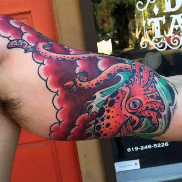 bicep-mens-swimming-squid-tattoo-with-red-ink