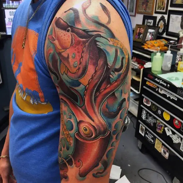 male-arm-tattoo-of-squid-with-tentacles-wrapped-around-fish