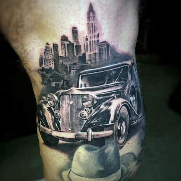 gangster-mens-lower-leg-tattoo-with-vintage-car-and-city-skylien-design