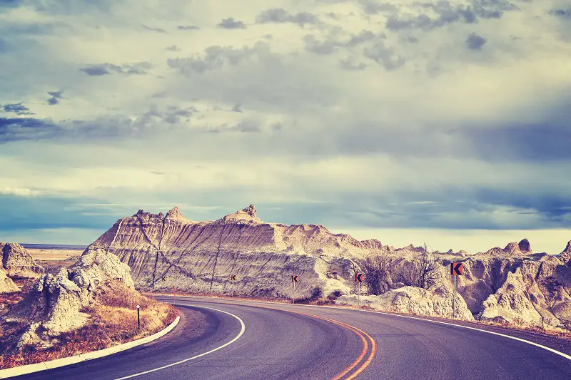 Vintage toned scenic road in Badlands National Park, USA.