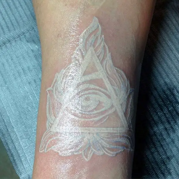 all-seeing-eye-white-ink-mens-wrist-tattoo