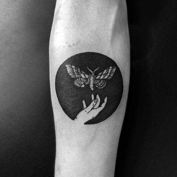 circle-negative-space-hand-with-moth-mens-inner-forearm-tattoos.jpg