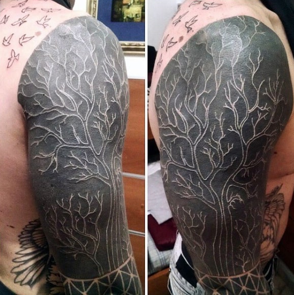 cool-white-ink-over-black-tree-branches-mens-sleeve-tattoo