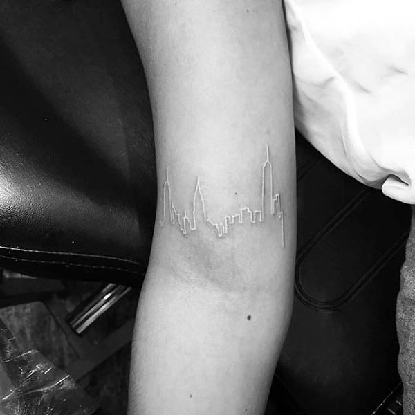 guys-city-skyline-white-ink-inner-forearm-tattoo