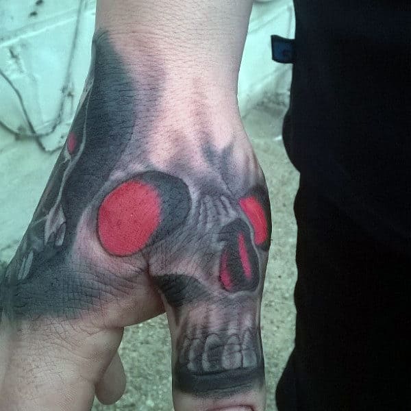 guys-glowing-red-skull-thumb-tattoo