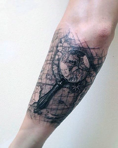 magnifying-glass-world-map-outer-forearm-mens-tattoo