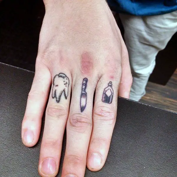 tooth-knife-and-bottle-male-tattoos-on-fingers