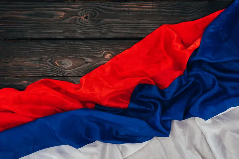 close up view of russian flag on dark wooden surface