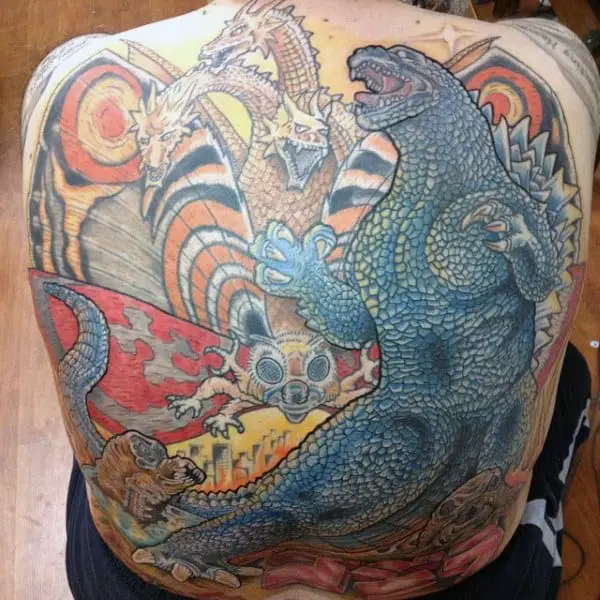 huge-back-piece-tattoo-of-godzilla-with-colorful-background-on-man
