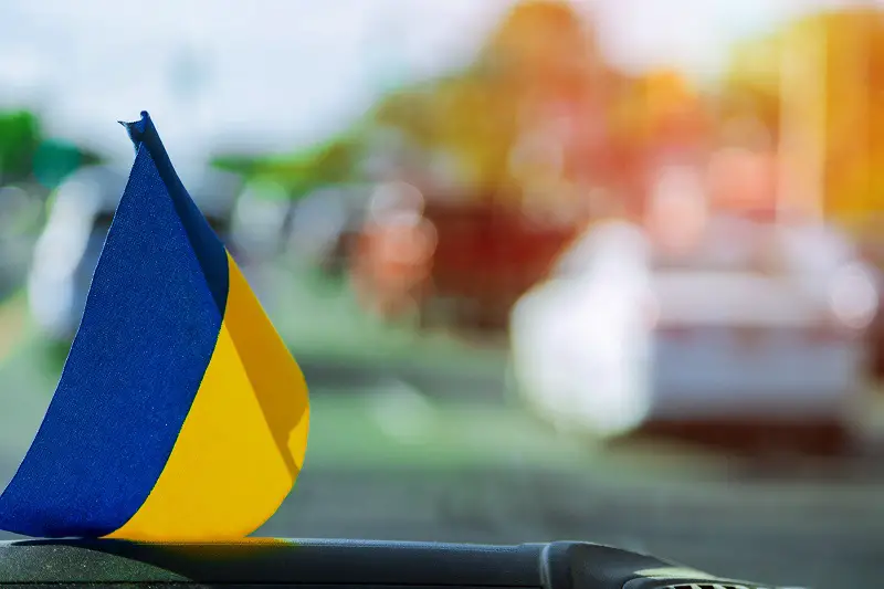 Ukrainian flag on glass inside the car