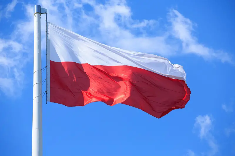 Polish flag on a background of blue sky