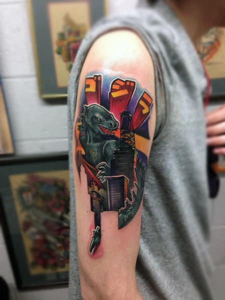realistic-graphic-tattoo-with-color-of-godzilla-on-mans-bicep