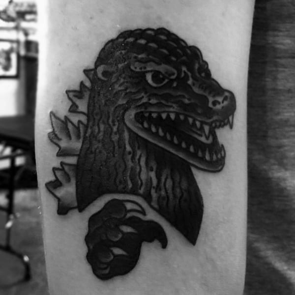shaded-black-tattoo-of-godzilla-on-guy