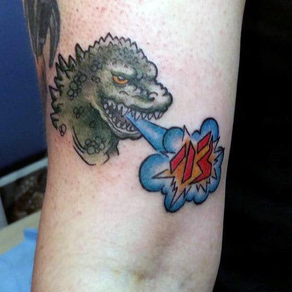 tiny-godzilla-speaking-japanese-tattoo-on-guys-inner-arm