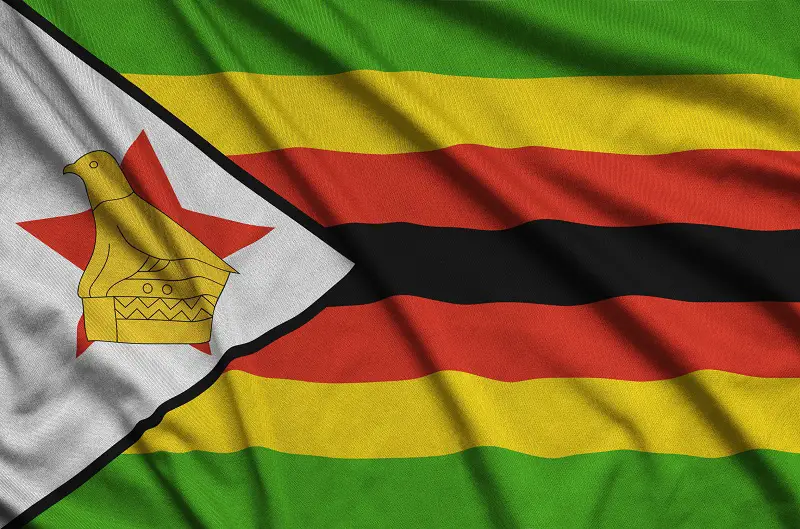 Zimbabwe flag is depicted on a sports cloth fabric with many folds. Sport team banner
