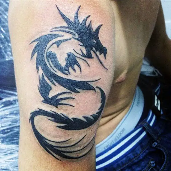back-of-bicep-mens-tribal-dragon-tattoos