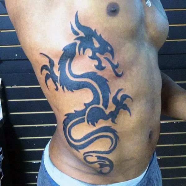 cool-tribal-dragon-tattoos-for-men-on-rib-cage-side-with-black-ink