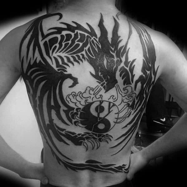 guys-tribal-dragon-back-tattoo