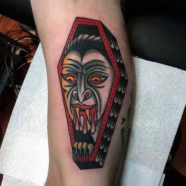 male-with-vampire-bites-tattoo-and-casket-on-forearm