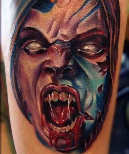mens-vampire-teeth-tattoo-on-upper-arm
