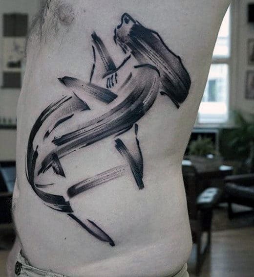 watercolor-paint-brush-stroke-tattoo-of-hammerhead-shark-on-mans-rib-cage-side