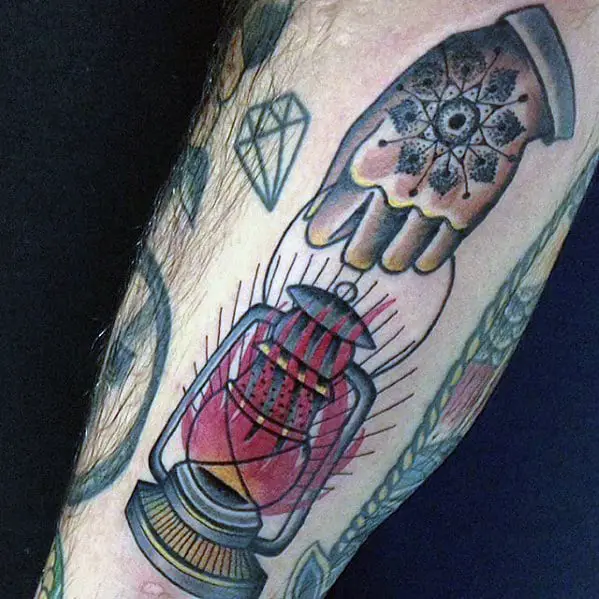 hand-holding-flaming-lantern-mens-traditional-leg-tattoo