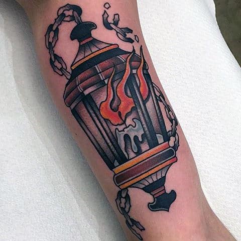 inner-arm-bicep-guys-flaming-lantern-with-broken-chains-traditional-tattoo