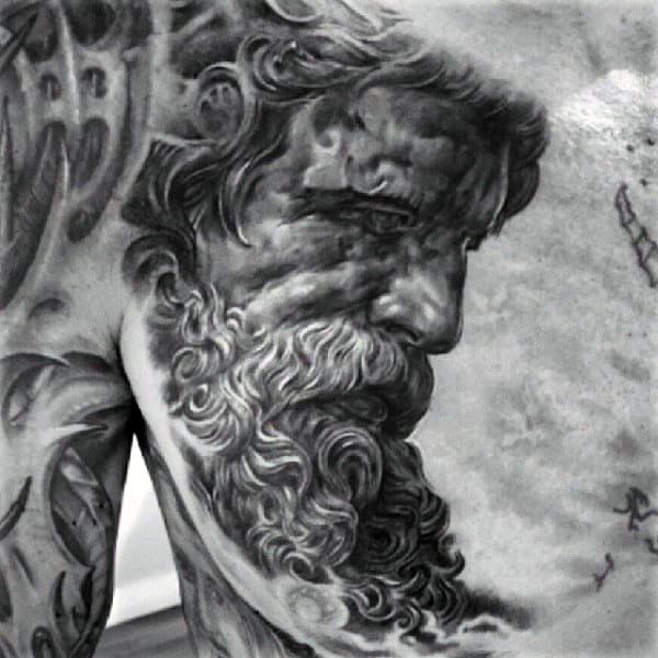 Black and grey Zeus portrait tattoo located on the