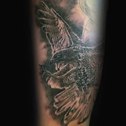 flying-shaded-grey-and-black-falcon-arm-tattoo-on-gentleman
