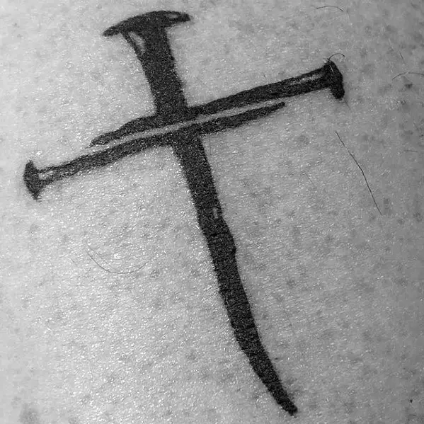 simple-cross-nails-mens-chest-tattoo-1